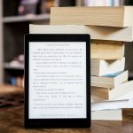 black tablet computer behind books